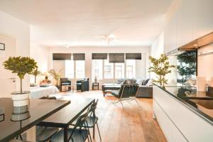 an open living room with a table and chairs at Apartment Light House. Heart of Antwerp in Antwerp