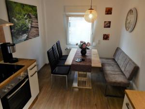 a living room with a table and a couch at Altstadt Charme in Cochem