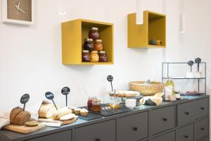 a counter with bread and other food on it at 8 Grappoli Agritur in Trento