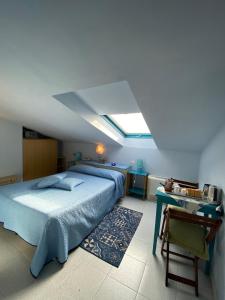 a bedroom with a bed and a skylight at Albergo La Pineta in Marina di Andora
