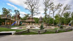 a playground in a park with a slide at Luxury Lakefront Villa 2Mi to Silver Dollar City POOL Theatre Room Kayaks in Branson
