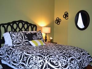 a bedroom with a black and white bed with pillows at Cumberland Inn and Spa in Cumberland
