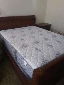 a white mattress on a bed in a room at The Ohio Motel in Bath