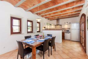 a kitchen and dining room with a table and chairs at Villa La Corbaia in Artá