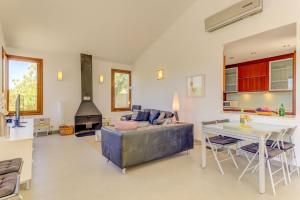 a living room with a couch and a table at Villa Vertent by Sealand Villas in Alcudia