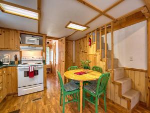 una cocina con mesa y sillas en una casa pequeña en Maggie Valley Cabin Rentals, en Maggie Valley