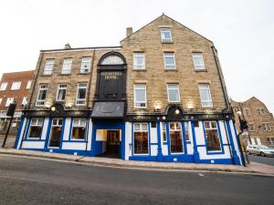 a building on the corner of a street at Churchill's Hotel in Wombwell