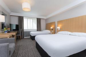 a hotel room with two beds and a television at Park Inn by Radisson Shannon Airport in Shannon