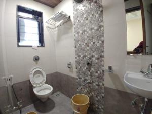 a bathroom with a toilet and a sink at Hotel Matruchhaya Lonavala - Premium Quality and comfort in Lonavala +39 photos