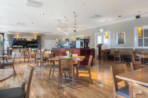 a dining room with wooden tables and chairs at Park Inn by Radisson Shannon Airport in Shannon
