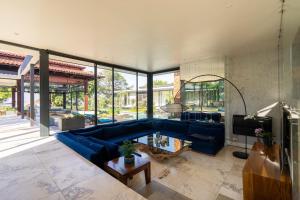 a living room with a blue couch and a tv at Umhlanga Beach Villa in Durban
