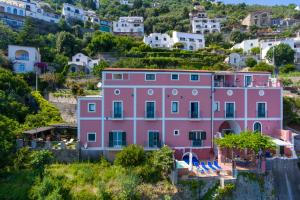 a pink house on the side of a hill at Palazzo Rocco Villa Red Moon in Love in Praiano