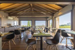 a dining room with tables and chairs and windows at Agriturismo La Razza in Reggio Emilia