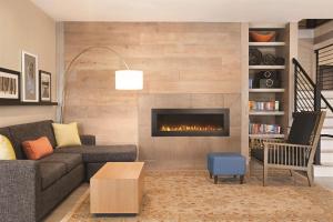 a living room with a couch and a fireplace at Country Inn & Suites by Radisson, Savannah Midtown, GA in Savannah