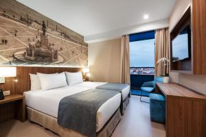Ein Bett oder Betten in einem Zimmer der Unterkunft Exe Saldanha