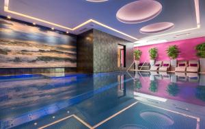 a swimming pool in a hotel with pink walls at ... mein romantisches Hotel Toalstock in Fiss