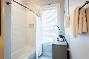 a bathroom with a bath tub and a sink at Semper Fi in Santa Rosa Beach +42 photos