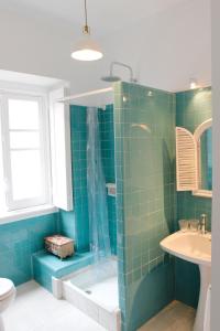 a bathroom with a shower and a toilet and a sink at Magnolia Guesthouse in Lisbon