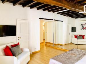 a living room with a white couch and a mirror at Palace fontana di trevi home in Rome