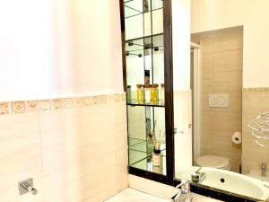 a bathroom with a sink and a toilet and a mirror at Palace fontana di trevi home in Rome +15 photos
