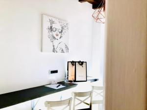 a room with a desk with chairs and a picture on the wall at Palace fontana di trevi home in Rome