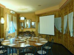 a room with a table with chairs and a projection screen at Hotel Sierra Madrona in Fuencaliente +28 photos