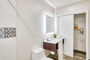 a bathroom with a toilet and a sink and a mirror at Villa 1565 - Saint Augustine in Saint Augustine