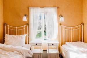 Ένα ή περισσότερα κρεβάτια σε δωμάτιο στο Utne Hotel