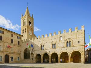 a large stone building with a clock tower at La Tana della Volpe B.&.B. in Montecassiano