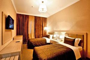 a hotel room with two beds and a television at Paradise Hotel Baku in Baku +49 photos