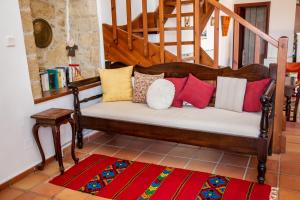 a bench with colorful pillows on it in a room at Agioklima Traditional Cretan House in Petrokefalo
