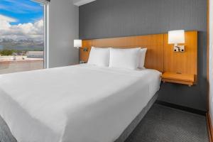 a hotel room with a bed and a window at Hyatt Place Anchorage-Midtown in Anchorage
