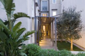 a hallway of an apartment building with a wooden walkway at Ucciardhome Hotel in Palermo
