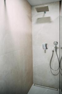 a bathroom with a shower with a shower head at Vistula Terraces Apartment in Kraków