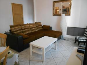 a living room with a couch and a table at Beau 3 pieces proche centre in Menton