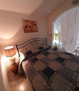 a bedroom with a bed and a large window at Casa Vacanze Gerardo in Mottola