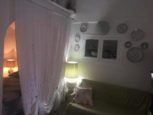 a bedroom with a bed and a white curtain at Casa Vacanze Gerardo in Mottola