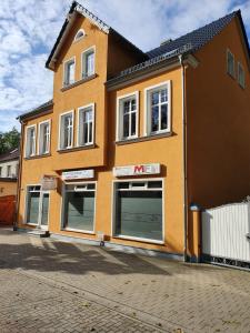 un edificio con tres puertas de garaje en una calle en APPARTEMENT Friedrich, en Zossen