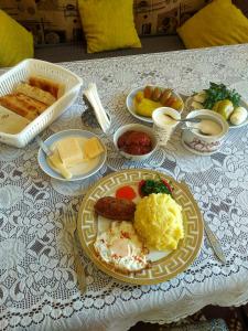 a table with a plate of breakfast food on it at NNN Guest House in Goris