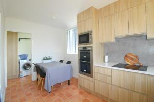 a kitchen with a table and a dining room at Main Stay 8, 1 Main Street in Crescent Head