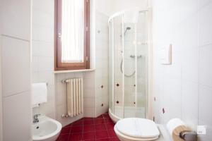 a bathroom with a shower and a toilet and a sink at Hotel Alessandro Della Spina in Pisa