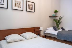 Posteľ alebo postele v izbe v ubytovaní 3D Wawel Apartament
