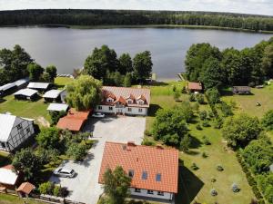 an aerial view of a house with a lake at Raciborówka in Świętajno