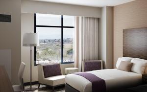 a hotel room with a bed and a large window at Estrella At Casino Del Sol in Tucson