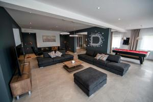 a living room with couches and a pool table at Villa D in Postira