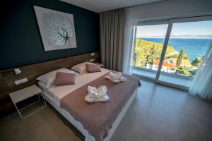 a bedroom with a bed with two towels on it at Villa D in Postira +32 photos