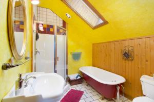 a bathroom with a tub and a sink and a bath tub at Juniper Lane Guest House in Friday Harbor