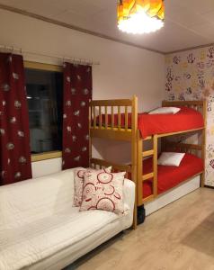 a bedroom with two bunk beds and a couch at Villa Seven in Rovaniemi