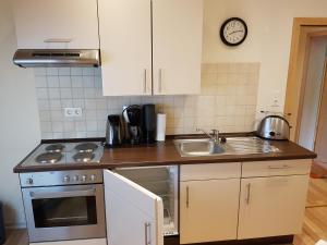 a kitchen with a sink and a stove top oven at Wolthusen in Emden