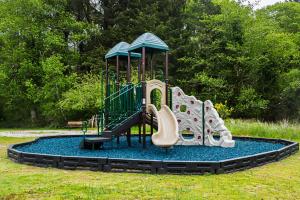 a playground with a slide in a park at Long beach Camping Resort Yurt 9 in Oceanview